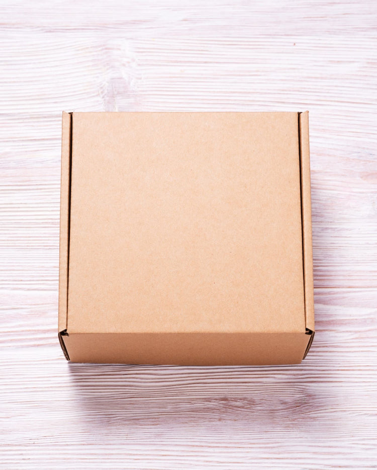 A kraft cardboard packaging box sitting on a table.